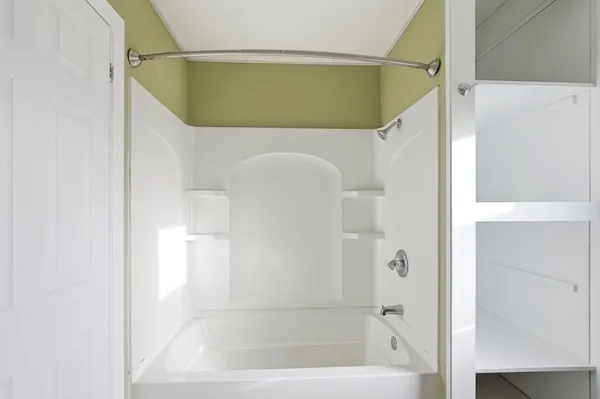 a bathroom with a bathtub and a shower
