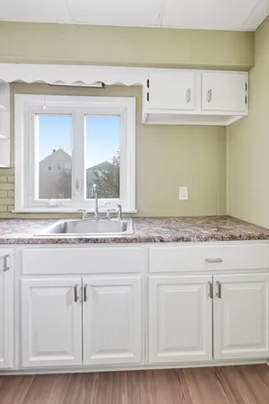 a bathroom with granite countertop a sink and vanity