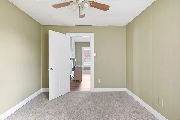 an empty room and a bathroom
