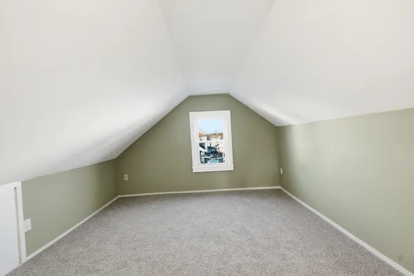 a view of a livingroom with wooden floor and a ceiling fan