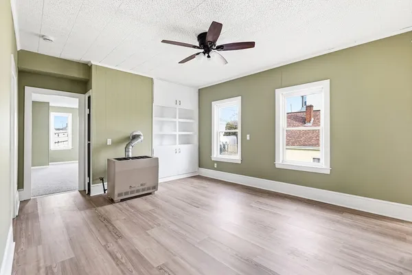 wooden floor in an empty room with a window