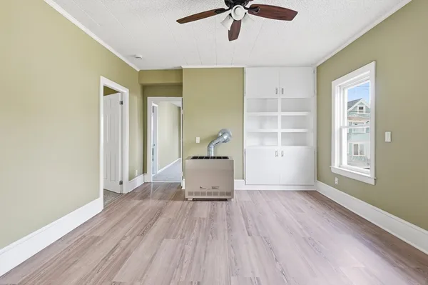 wooden floor in an empty room with a window