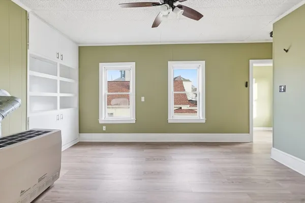 a view of room with window and wooden floor