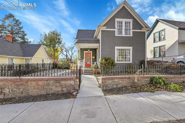a view of a brick house with a yard