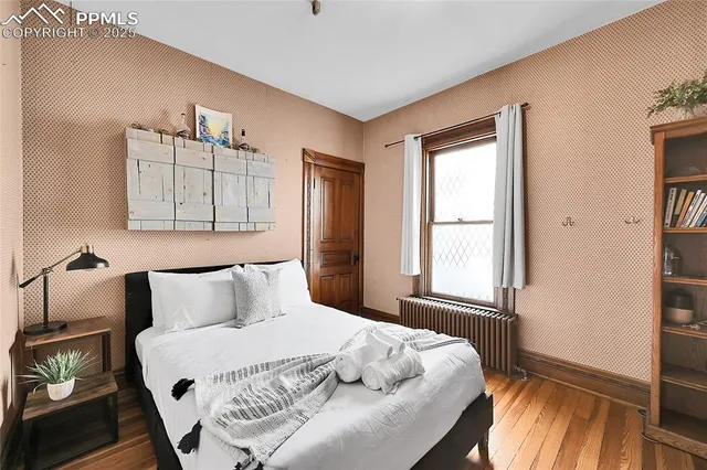 a bedroom with a bed and a window