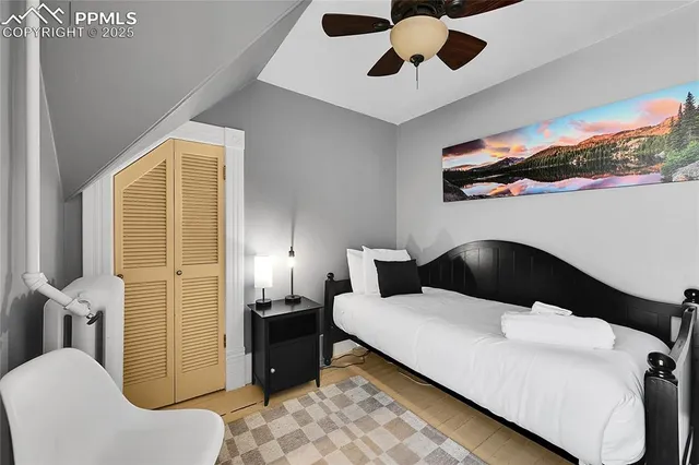 a bedroom with a bed and ceiling fan