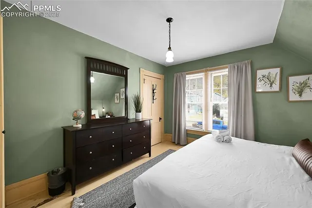 a bedroom with a bed and a dresser