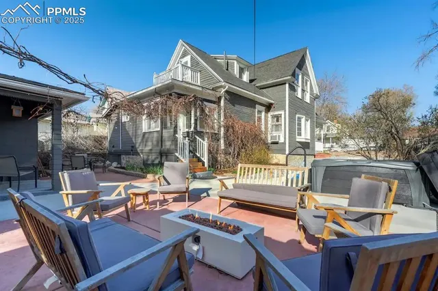 a view of a patio with table and chairs and floor to ceiling window