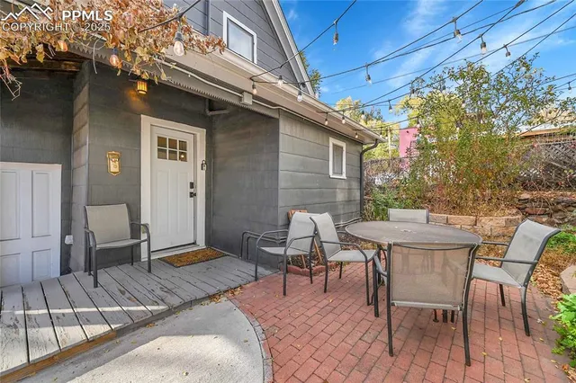 a patio with table and chairs