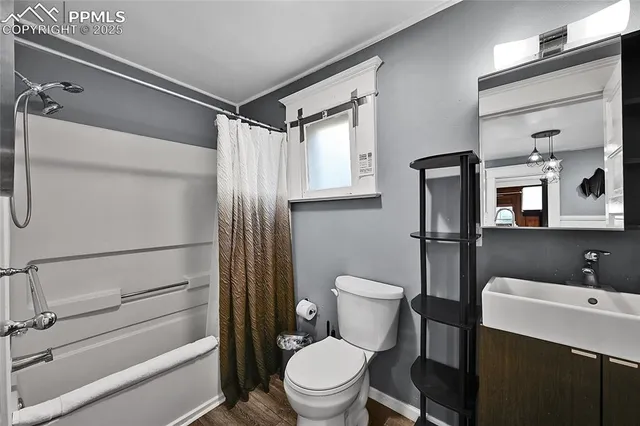 a bathroom with a toilet and a shower