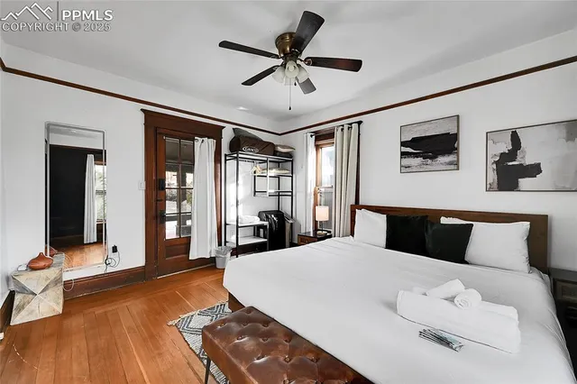 a bedroom with a bed and a flat tv screen on dresser