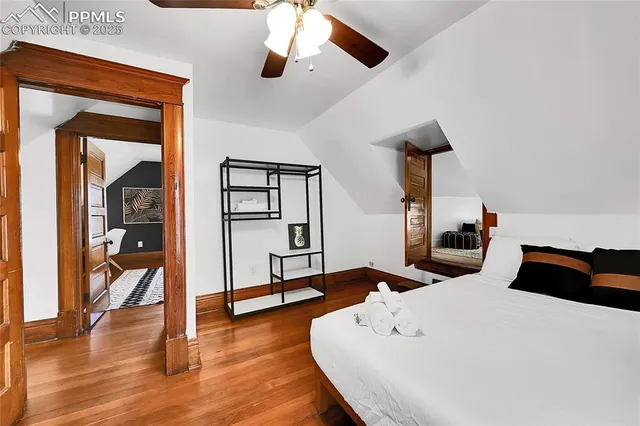 a bedroom with a bed and a large mirror