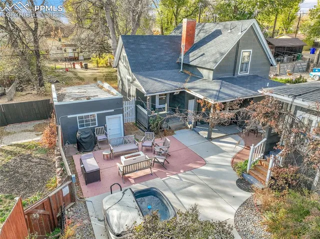 an aerial view of a house with garden space and sitting area