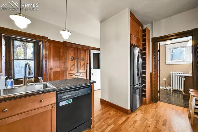 a kitchen with stainless steel appliances granite countertop a refrigerator and a sink