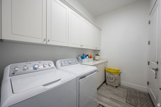 4708 Martin Drive St. George, UT 84790 - Photo 23 of 28 Laundry room featuring light wood-type flooring, cabinet space, and washing machine and clothes dryer