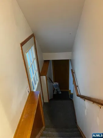 a view of staircase with wooden floor and chair