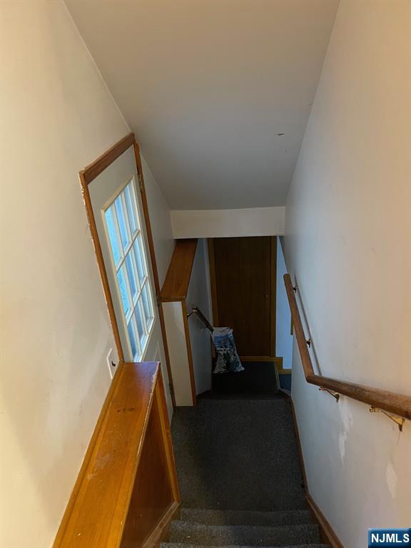 3 Ann Street, Unit 1F Harrison, NJ 07029 - Photo 14 of 15 a view of staircase with wooden floor and chair
