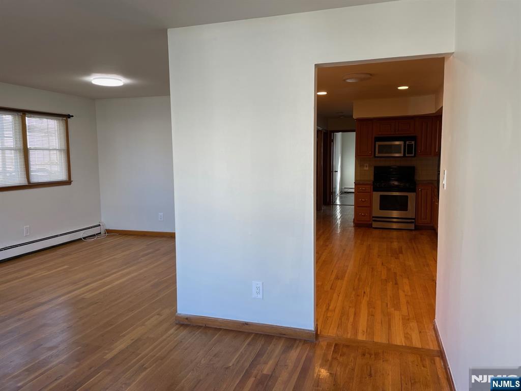 3 Ann Street, Unit 1F Harrison, NJ 07029 - Photo 3 of 15 wooden floor in an empty room with a window