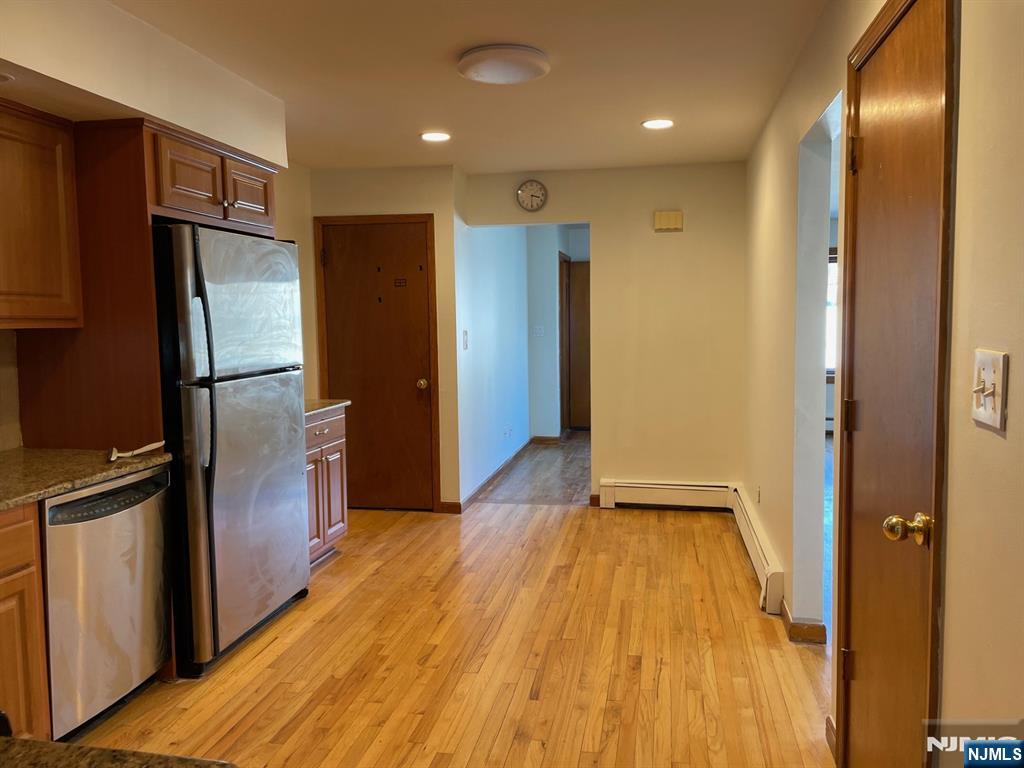 3 Ann Street, Unit 1F Harrison, NJ 07029 - Photo 7 of 15 a view of a refrigerator in kitchen and wooden floor