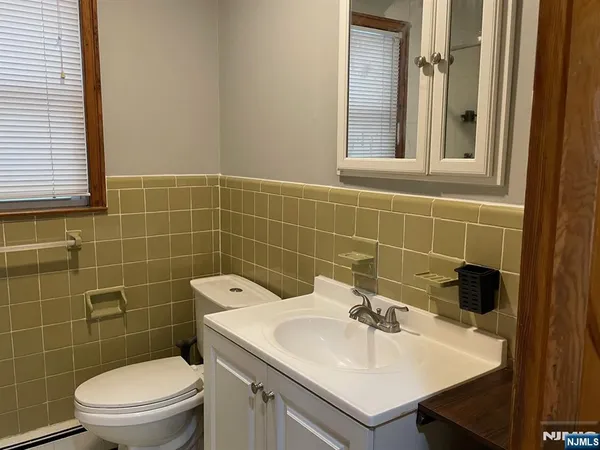 a bathroom with a sink a toilet and a mirror