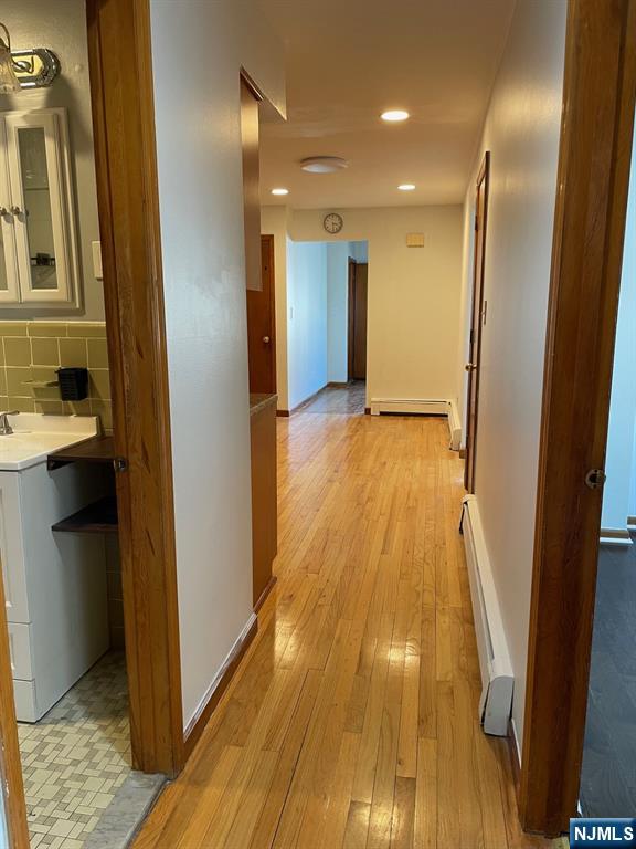 3 Ann Street, Unit 1F Harrison, NJ 07029 - Photo 10 of 15 a view of hallway with wooden floor
