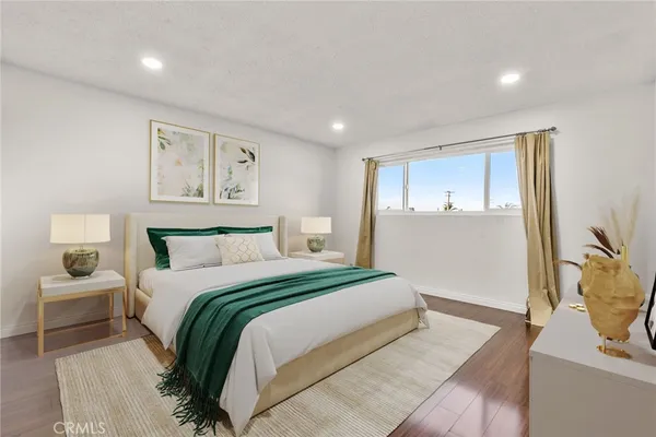 a bedroom with a large bed and a couch