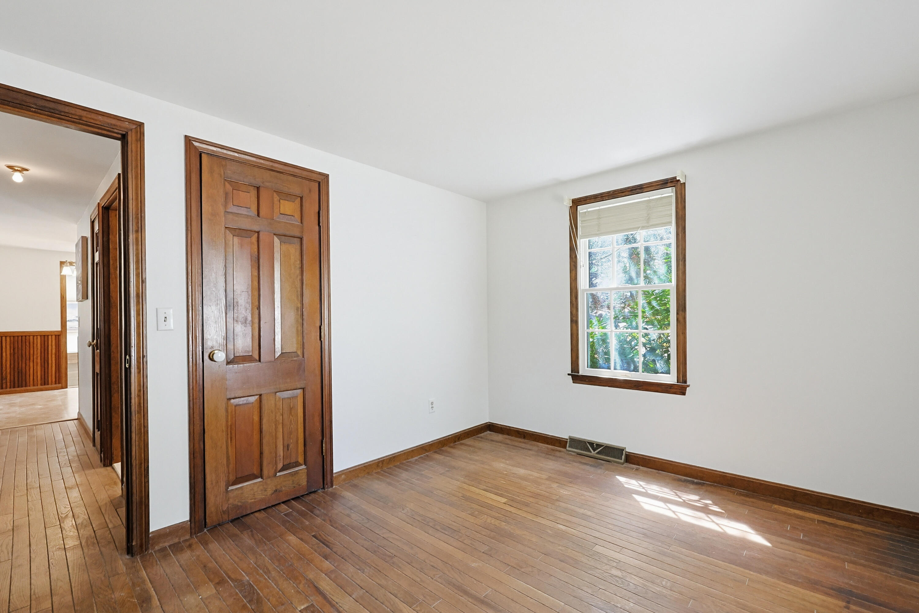 556 Cotuit Road Mashpee, MA 02649 - Photo 11 of 45 an empty room with wooden floor and windows
