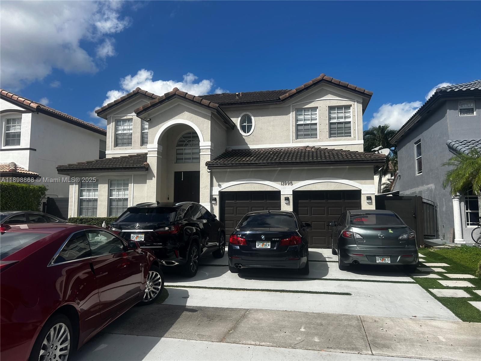 13995 Southwest 154th Street, Unit 2 Miami, FL 33177 - Photo 1 of 11 a view of a car parked in front of a building