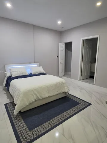 a bedroom with a bed and dresser