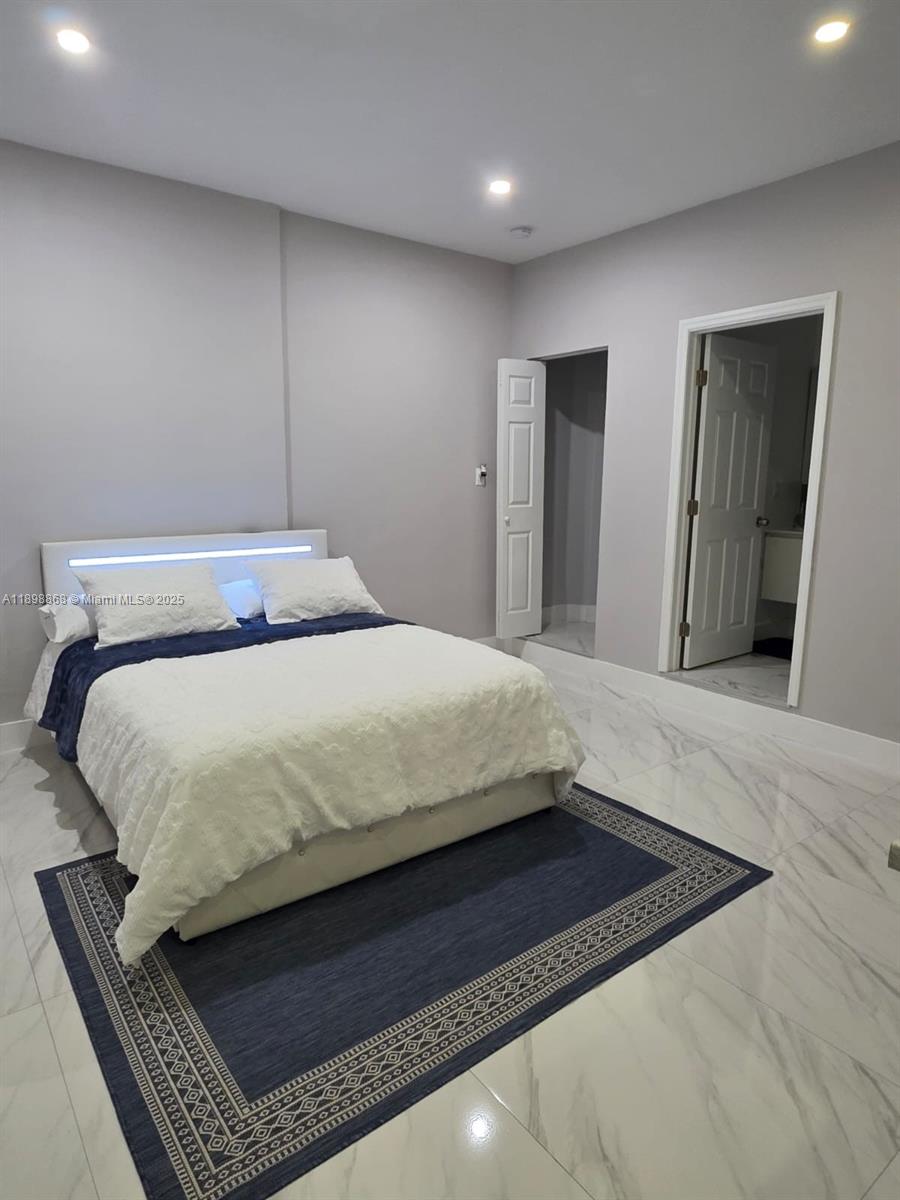 13995 Southwest 154th Street, Unit 2 Miami, FL 33177 - Photo 3 of 11 a bedroom with a bed and dresser