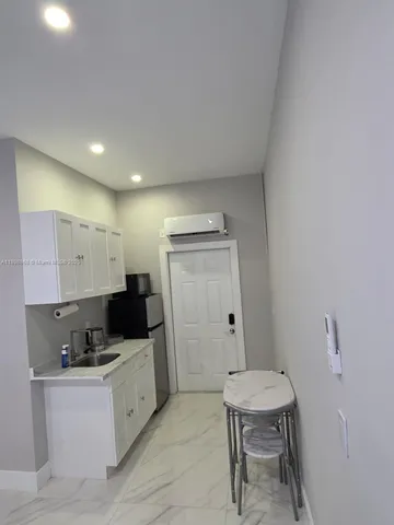 a kitchen with stainless steel appliances a stove a sink and a refrigerator