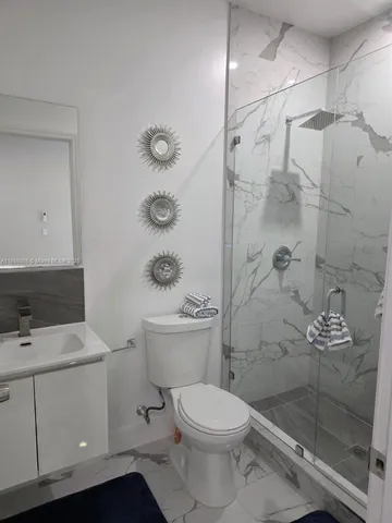 a bathroom with a toilet sink and shower