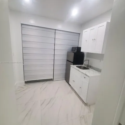 a view of storage and utility room with closet