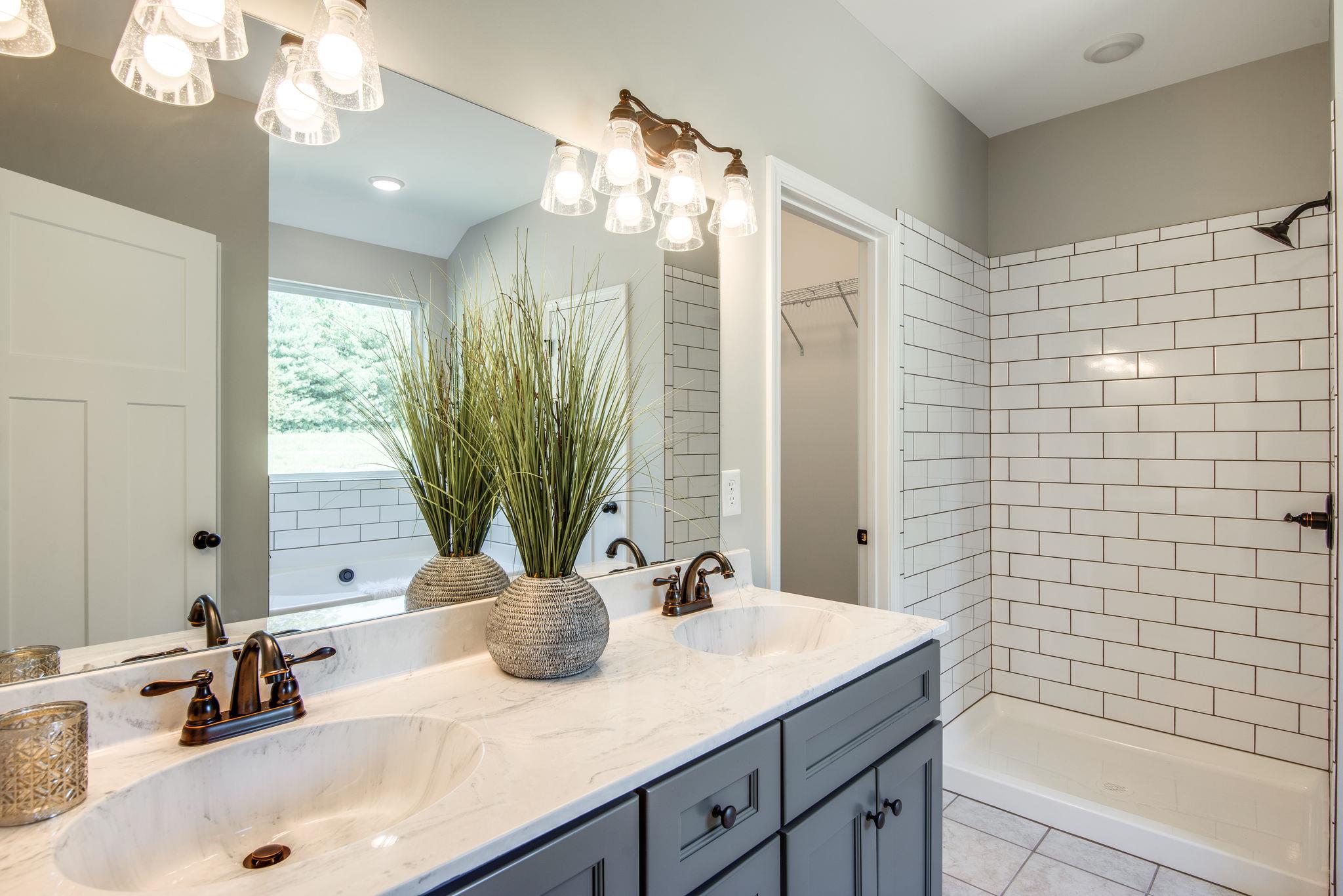 1507 East Piney Road Dickson, TN 37055 - Photo 17 of 30 a bathroom with a granite countertop sink a large mirror and shower