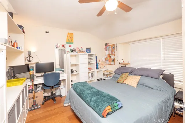 a bedroom with a bed and a tv on the dresser