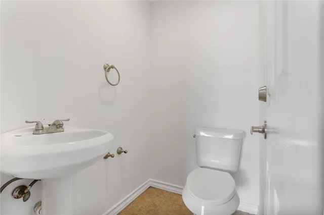 a front view of a house with a garden and yard