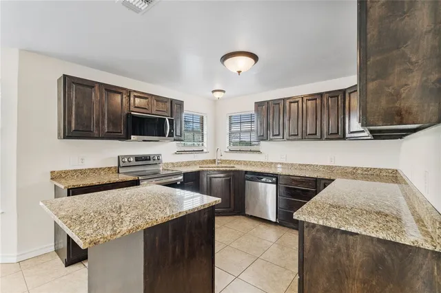 a kitchen with a stove sink and microwave