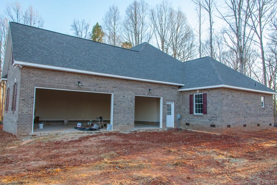 707 Cooks Cove Ridge Clover, SC 29710 - Photo 3 of 18 a backyard of a house with table and chairs under an umbrella