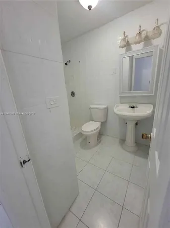 a white toilet sitting next to a bath tub