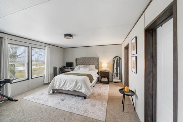a bathroom with a granite countertop tub sink and mirror