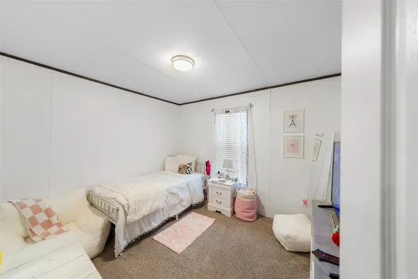 a bedroom with furniture and a chandelier