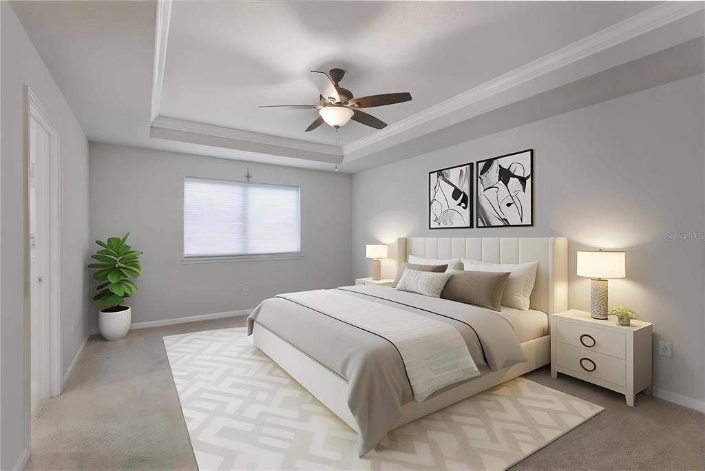 19431 Monarch Wind Way Lutz, FL 33558 - Photo 6 of 17 a bedroom with a large bed and a chandelier fan