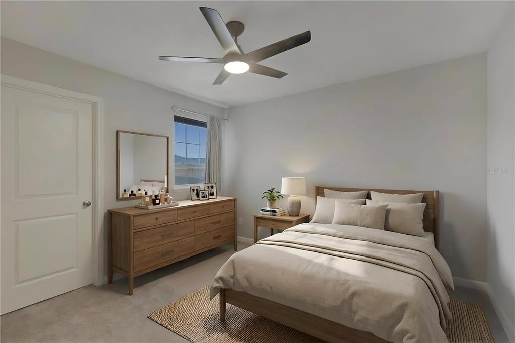 19431 Monarch Wind Way Lutz, FL 33558 - Photo 8 of 17 a bedroom with a bed and ceiling fan