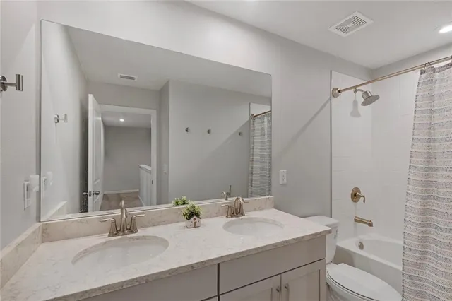 a bathroom with a sink toilet tub and shower