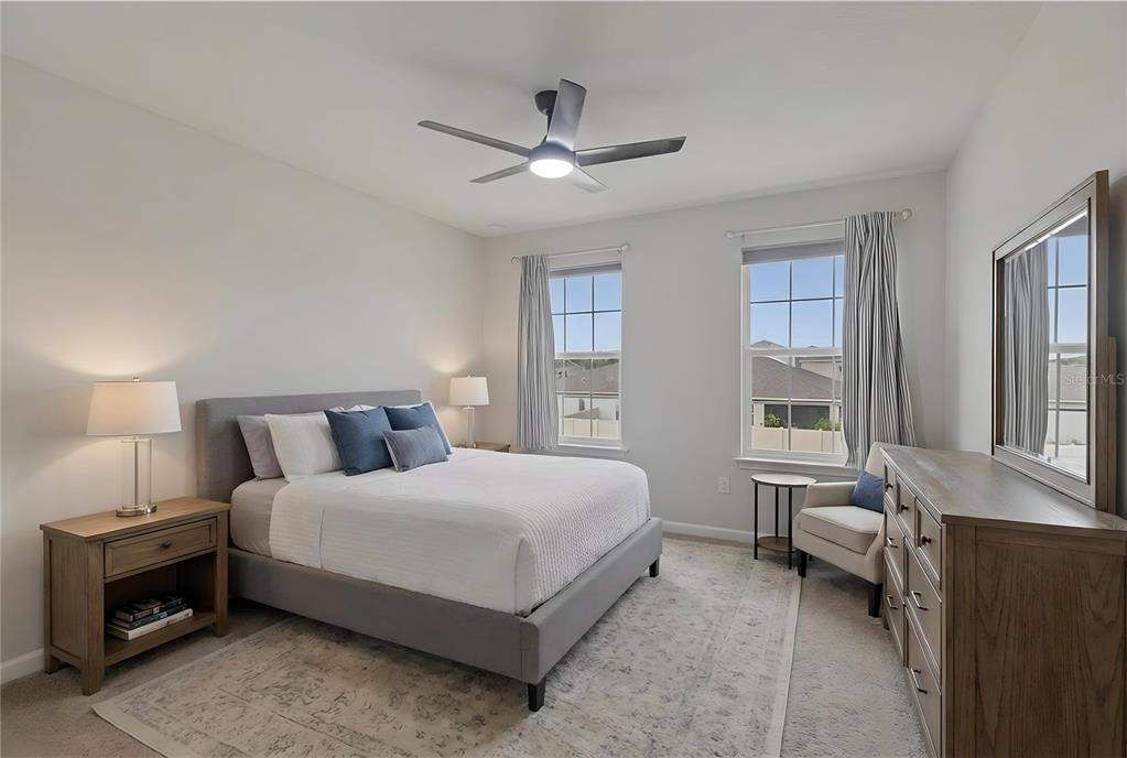 19431 Monarch Wind Way Lutz, FL 33558 - Photo 10 of 17 a bedroom with a bed and a couch