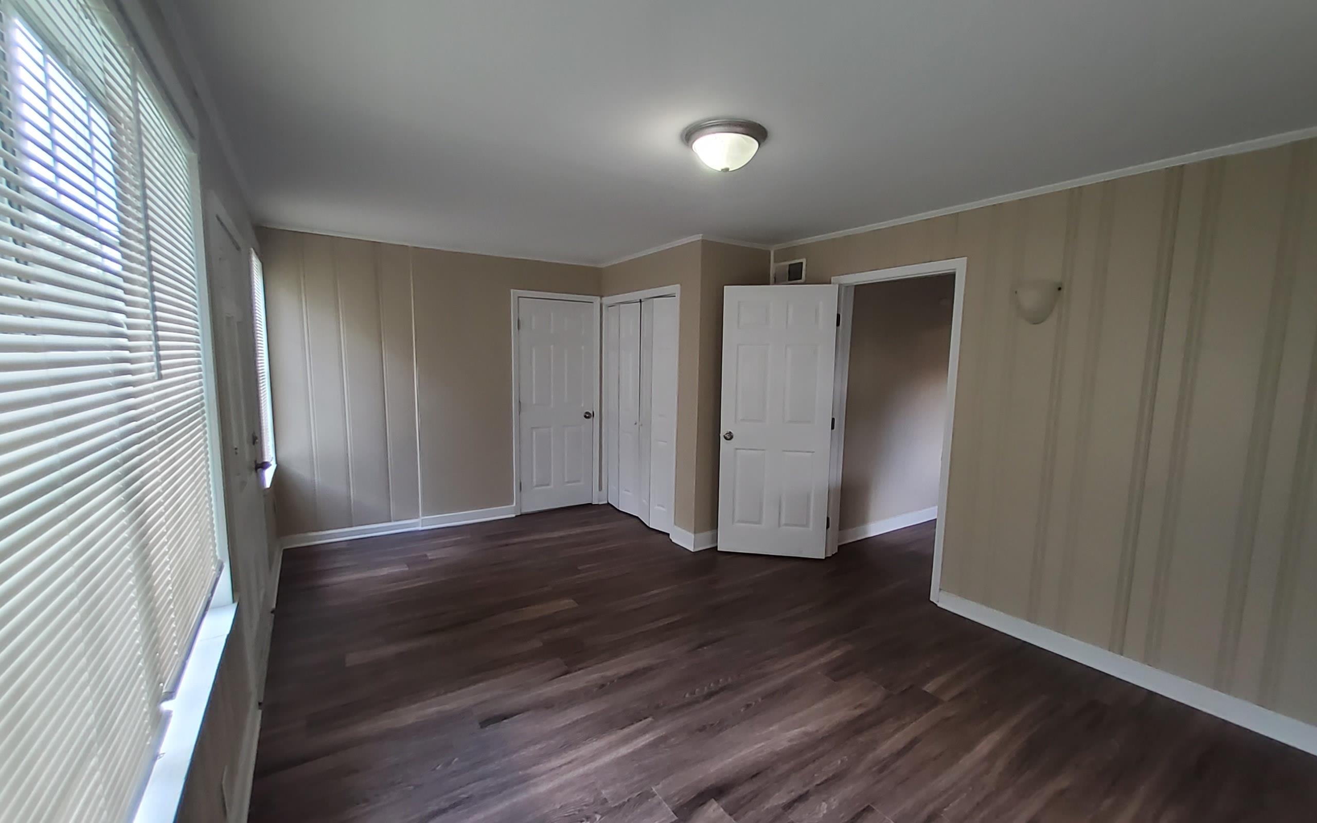 1401 Alamo Street Memphis, TN 38114 - Photo 11 of 11 a view of an empty room with wooden floor and a window