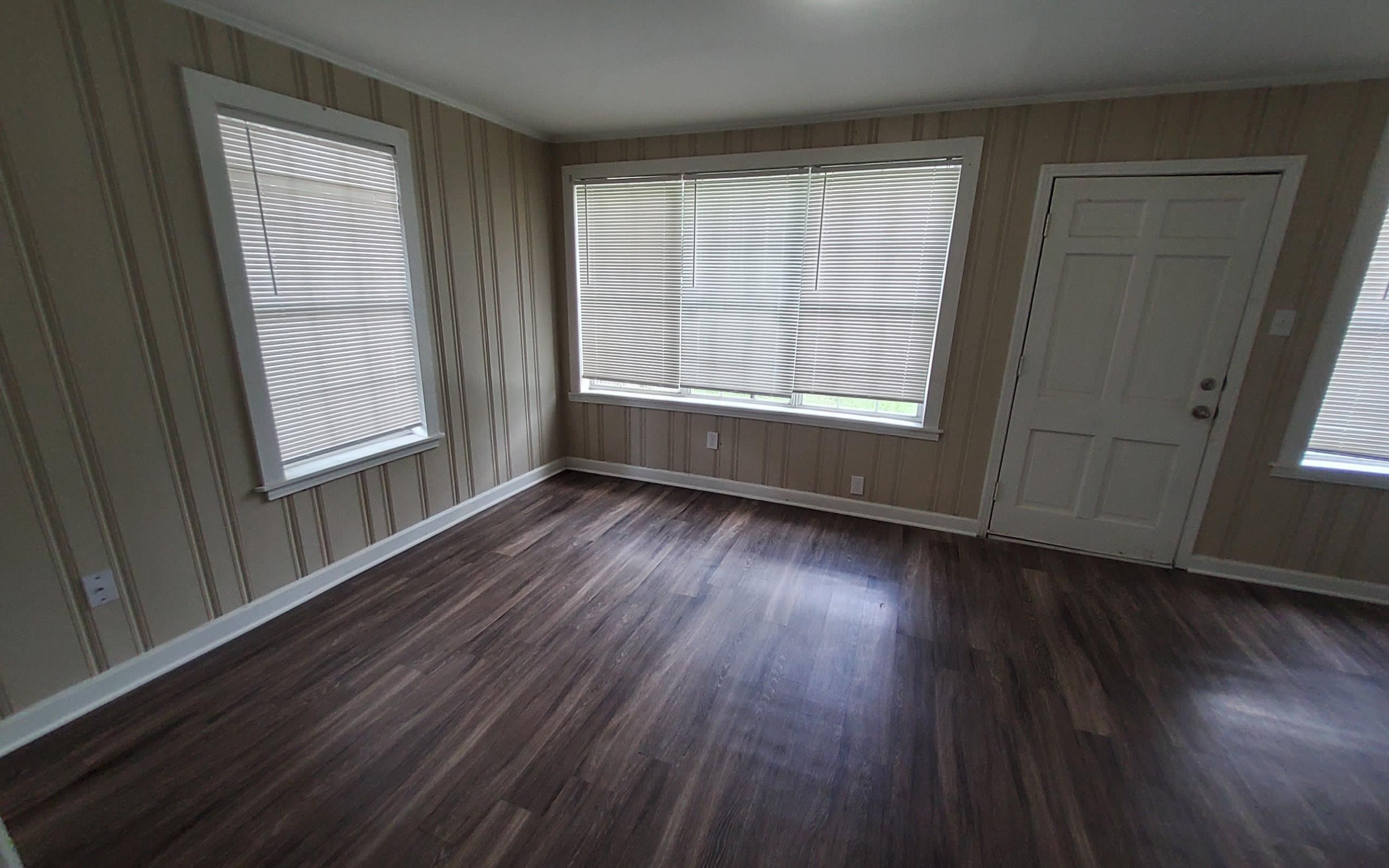 1401 Alamo Street Memphis, TN 38114 - Photo 3 of 11 an empty room with wooden floor and windows