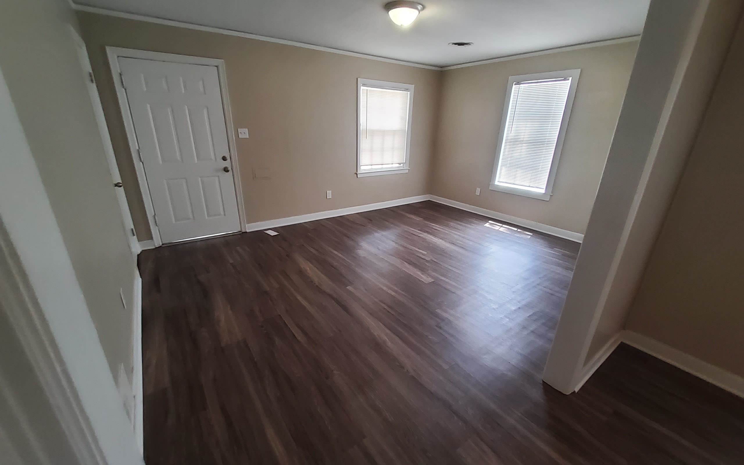 1401 Alamo Street Memphis, TN 38114 - Photo 4 of 11 a view of an empty room with wooden floor and a window