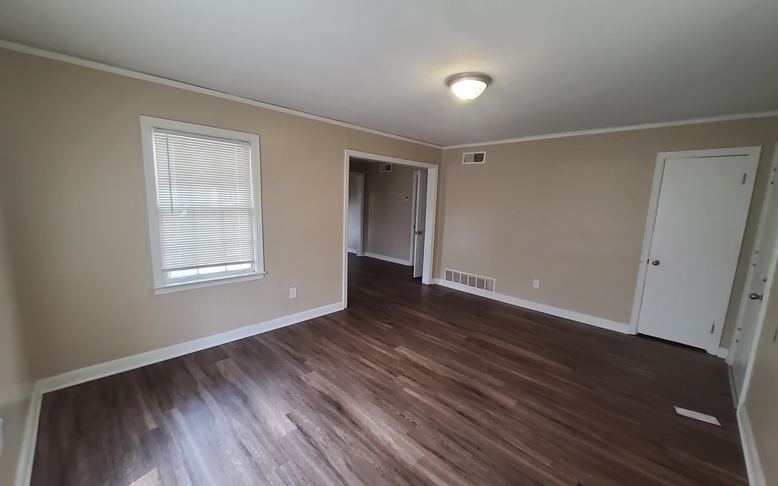 1401 Alamo Street Memphis, TN 38114 - Photo 5 of 11 a view of an empty room with wooden floor and a window
