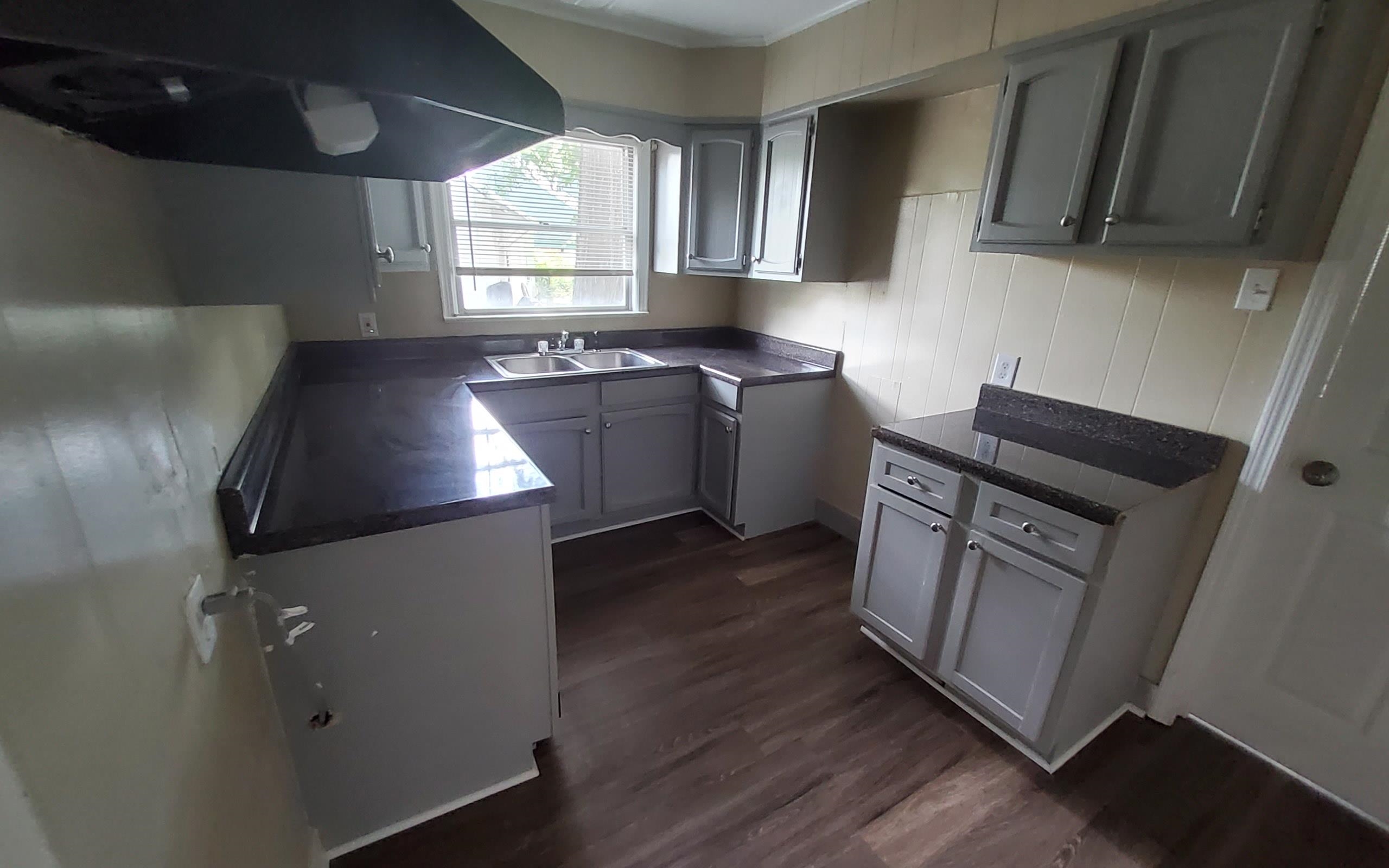 1401 Alamo Street Memphis, TN 38114 - Photo 6 of 11 a kitchen with granite countertop a sink a stove a refrigerator and cabinets